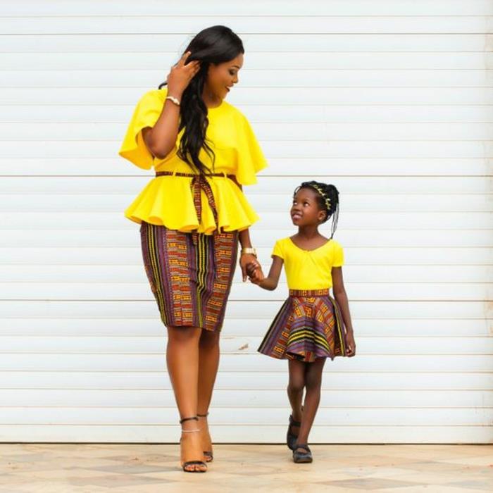 palaidinės geltonos spalvos mamai ir dukrai, sijonai su afrikietiškais raštais, tiesus sijonas mamai ir lambada tipo sijonas mažyliui, drabužiai iš vaško, afrikietiška mada