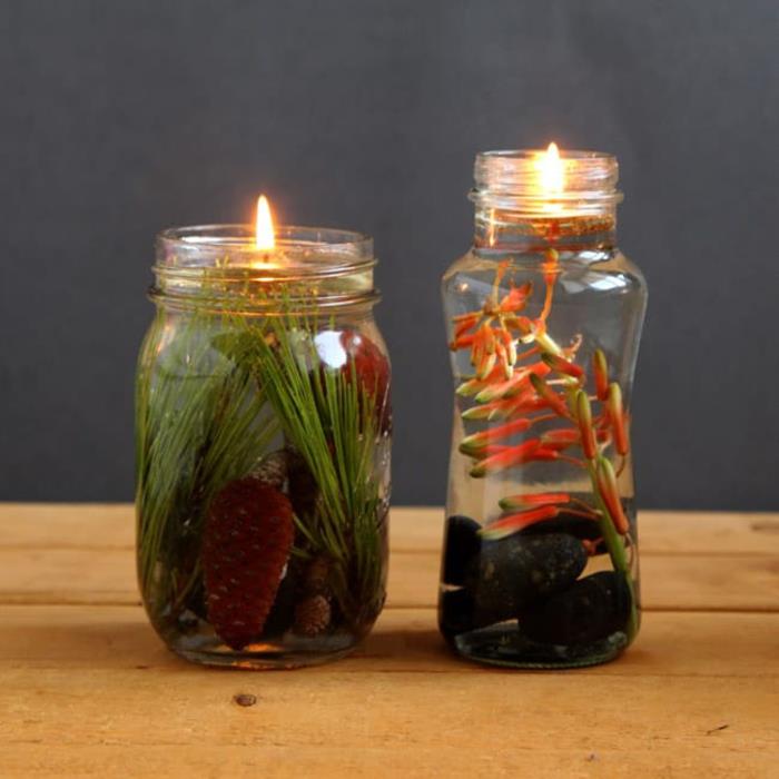 svetilka za kozarec z rastlinskim oljem in plavajočim stenjem, okrašenim z rastlinami in kamenčki