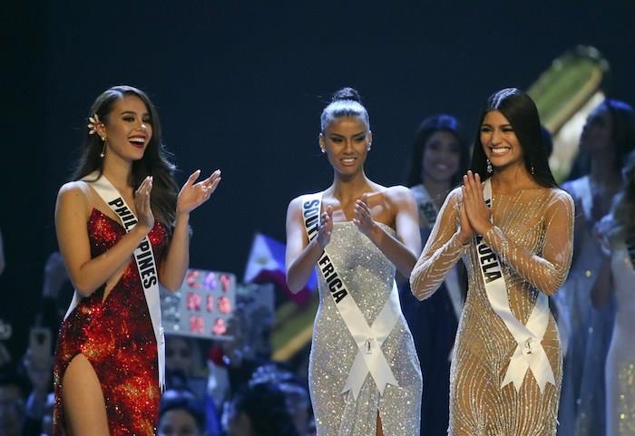 2018 Volitvena slovesnost Miss Universe Catriona Grey v rdeči obleki in dve Dauphines Miss Južne Amerike in Miss Venezuele