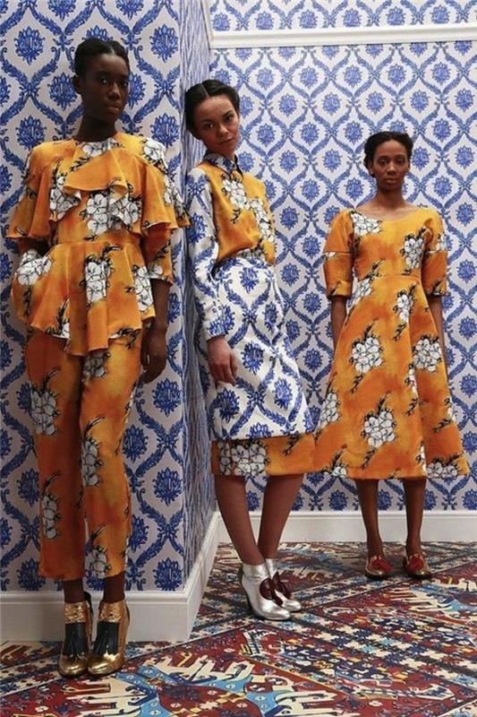 trys išvaizdos, dvi afrikietiškos suknelės ir vienas žvilgsnis į kelnes, afrikietiškas raštas, baltos gėlės ant oranžinio pagrindo, suknelė su platėjančiu sijonu ir tiesi suknelė