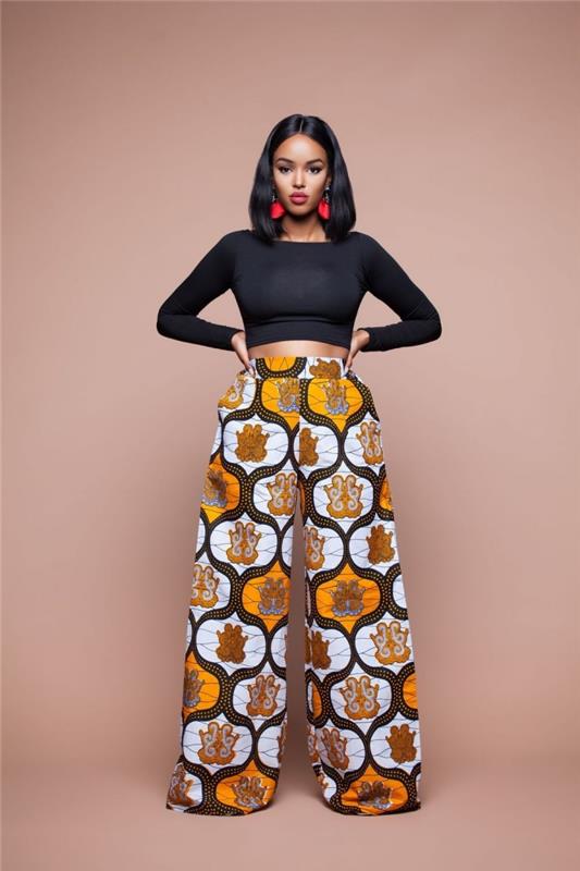 etninių papuošalų idėja moterims, plačios afrikietiško stiliaus kelnių modelis, moteriška apranga juodos spalvos viršutinėje dalyje ir etninės kelnės